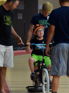 child learning to ride bike