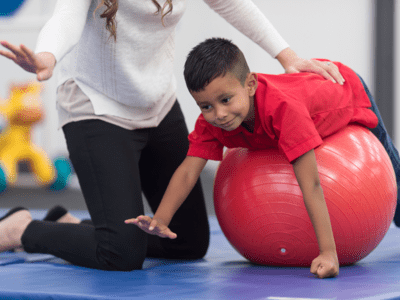 Boy on therapy ball in physical therapy