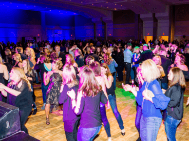 group of people dancing in a ballroom