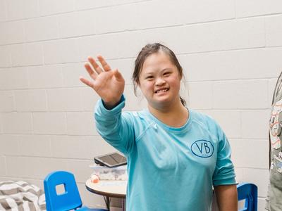 Girl waving to the camera