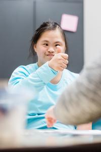 A young girl giving a "thumbs up"