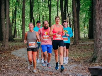 a group of runners in the woods